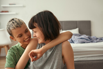 Happy lesbian couple resting and hugging at home