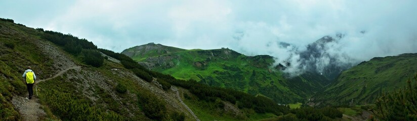 Austrian Alps - panoramic view of a hiker on the trail and the Juppenspitze mountain near the town of Lech in the Lechtal Alps