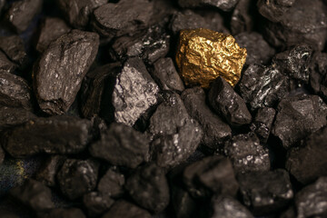 hard coal in the pile. a piece of gold among the coal. extracted underground.