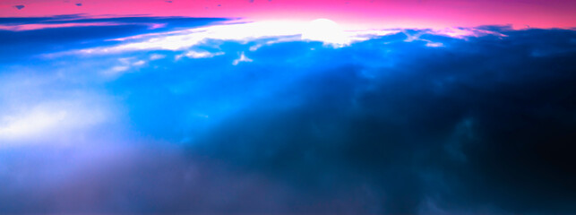 Naklejka na ściany i meble Majestic sunrise aerial view over the blue clouds on the pink sky background