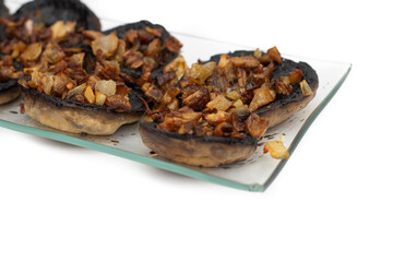 Mushrooms stuffed with garlic and onion, Spanish food. Isolated on white background. Selective focus.