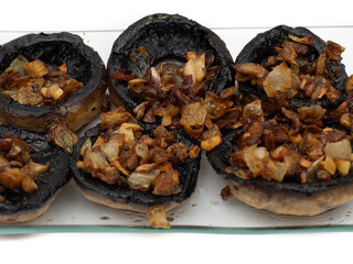 Mushrooms stuffed with garlic and onion, Spanish food. Isolated on white background. Selective focus.