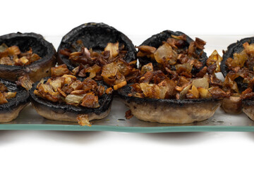 Mushrooms stuffed with garlic and onion, Spanish food. Isolated on white background. Selective focus.