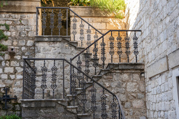 Detail of the ancient cast iron railing on a stone staircase in the old town of Kotor, Montenegro