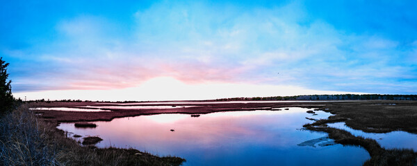 Sunrise seascape with blue clouds at the wildlife seabird sanctuary in Mashpee on Cape Cod