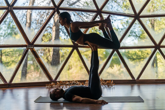 Couple practicing bow pose in studio