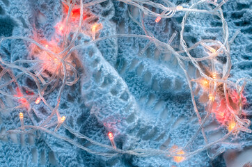 Abstract christmas background with festive garland lights. Close-up, selective focus.
