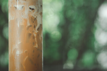 Close up of iced coffee mocha show milk cream in a tall glass
