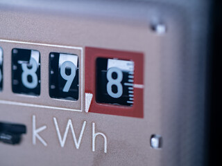 Close-up electricity meter. Measuring used electricity in kWh ( kilowatt hour ) - obrazy, fototapety, plakaty