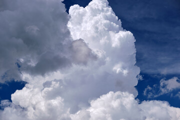 Bright landscape of white puffy cumulus clouds on blue clear sky