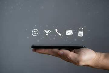 Male hand using smartphone, contact us. Connection concept
