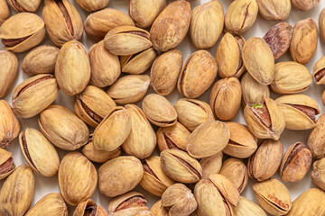 Background of ripe pistachio nuts with cracked shells