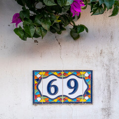 Typical architecture of Algarve building's house numbers.