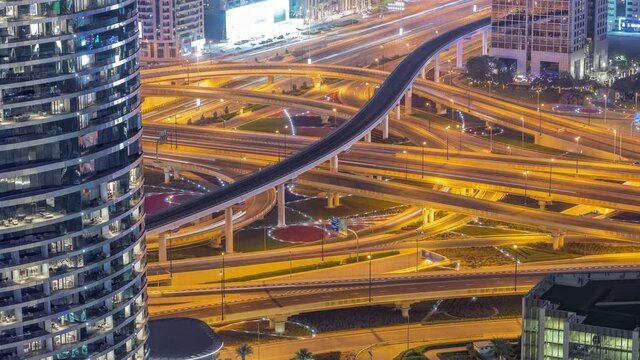 Highway intersection and overpass of Dubai downtown aerial night timelapse.