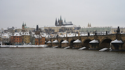 Fototapeta na wymiar Magical winter time in Prague, historic castle and bridge covered with snow, Prague winter cityscape, Czech Republic