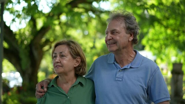 Happy senior couple walking together outside, older 60s people relationship