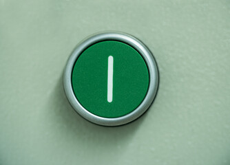 Green push button on a switchboard to control electricity power for an apartment building. 