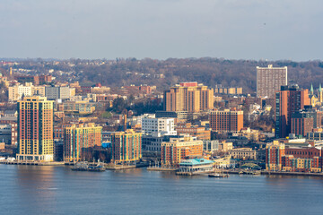 Yonkers, NY / United States - Dec. 24, 2021: a wide landscape view of Yonker's historic waterfront, made up of restaurants, shops and residential buildings.