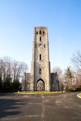 Fototapeta na wymiar Alpine, NJ - USA - Dec. 24, 2021: View of Rionda’s Tower and Historical Marker, formerlly known as the Alpine Stone clock tower or the Devil's Tower. Erected in 1910 by sugar baron Manuel Rionda.