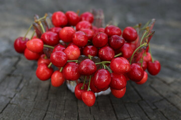 Fresh red Sweet cherry on the  wooden table. Red Cherry. Food background. Fresh ripe sour Cherries with stalks. Fresh . Red Juicy Sweet cherries  on wooden background. Diet healthy food.
