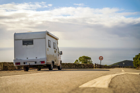 Small camper van parked on the side of the road in Arrabida Natural Park, Portugal