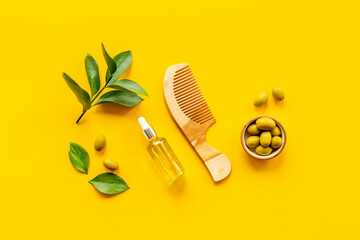 Hair treatment olive oil with hair comb. Top view