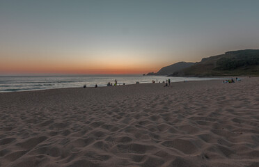 Last view of the sun at Finisterre Beach, endpoint of the Camino de Santiago