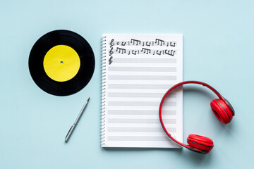 Sheets with music notes and headphones. Compose music concept