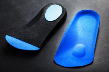 Orthopedic insoles for correction of pronation of the foot on a dark background.