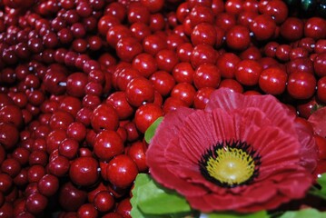 
Background from red natural stone beads of ruby ​​color. Red bead necklaces. Crafts, handicrafts, jewelry making