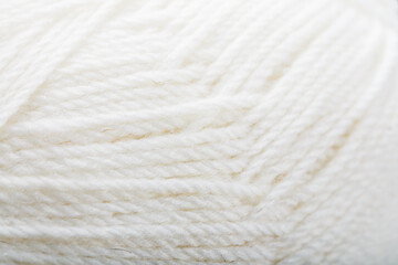 White threads of natural wool close-up in full screen