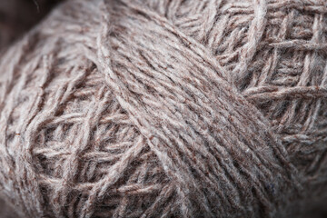 Balls of brown wool yarn made of natural wool.