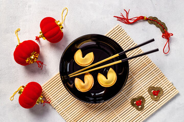 Chinese New Year tabble setting with fortune cookies and golden chopsticks
