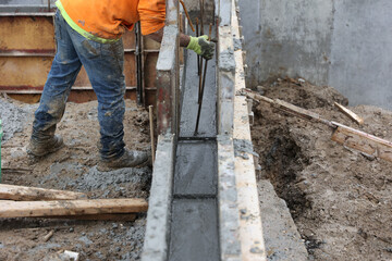 Rebar is placed in newly poured concrete.