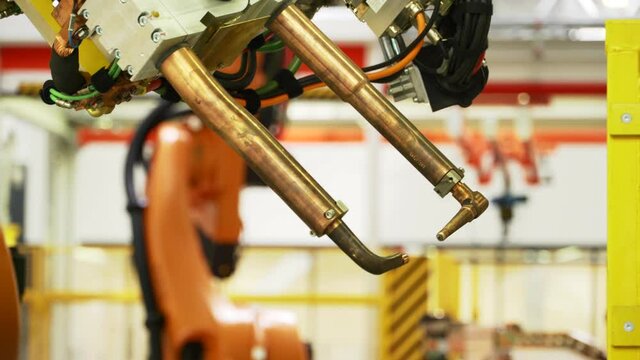 Latest technology in machine production. Scene. Robotic machines working in production of cars and parts. New technologies and robotization in production