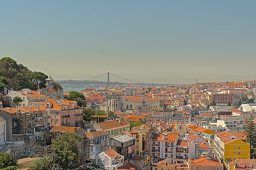 Fototapeta na wymiar Rooftops of the houses of Lisbon, with Tagus river in the background, Portugal 