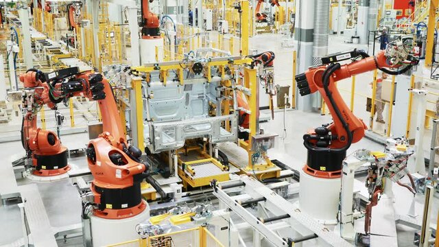Latest technology in machine production. Scene. Robotic machines working in production of cars and parts. New technologies and robotization in production