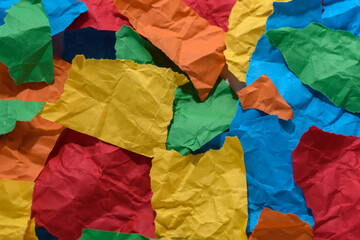 Decoration of torn multicolored papers. Crumpled papers.
