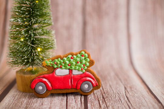 Christmas gingerbread on a wooden background with lights and a place for text. Beautiful homemade  Christmas gingerbread . Tiger, car, mitten, hat gingerbread.