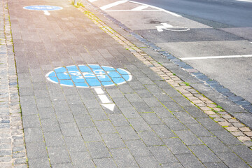 Empty brick bicycle lane running along along a street in a city centre. Bonn, Germany.