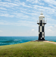 Fototapeta na wymiar Port Shepstone Lighthouse with turquoise blue indian ocean water