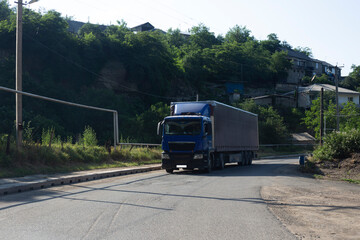 Fototapeta na wymiar blue truck in road in forest