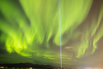 Green Aurora Borealis / Northern Lights Hole Sky with light beam, Iceland.