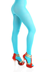 Side view of female legs in nylon tights and high-heels on isolated white background