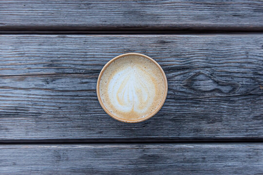 Coffee on wooden table, photographed from above