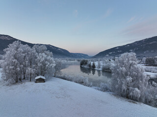 Drone photo fra Hallingdal, Nesbyem. The river is freezing but it is warmer than the air. Frost smoke. 