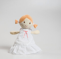 Christmas doll angel made of fabric and wool, soft toy isolated on white background.