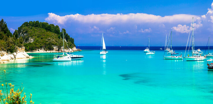 splendid beaches of Paxos. Ionian islands of Greece .Beautiful turquoise bay in Lakka. view with sailing boats. Greek summer vacation