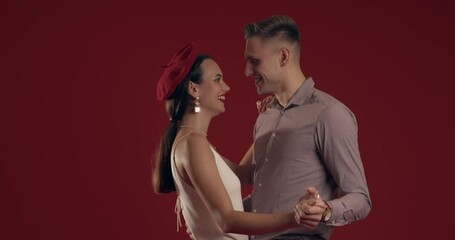 Happy dancing couple in love on red background. Valentines Day celebration