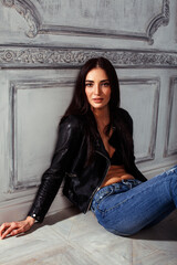 Fototapeta na wymiar young brunette woman in leather jacket at vintage wall, lifestyle people concept